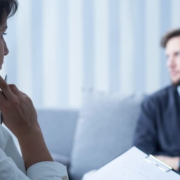 Psychologist talking to patient